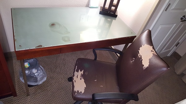 Worn out chair in a dirty hotel room